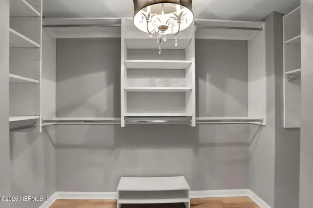 a bathroom with a bathtub shower sink vanity mirror and toilet