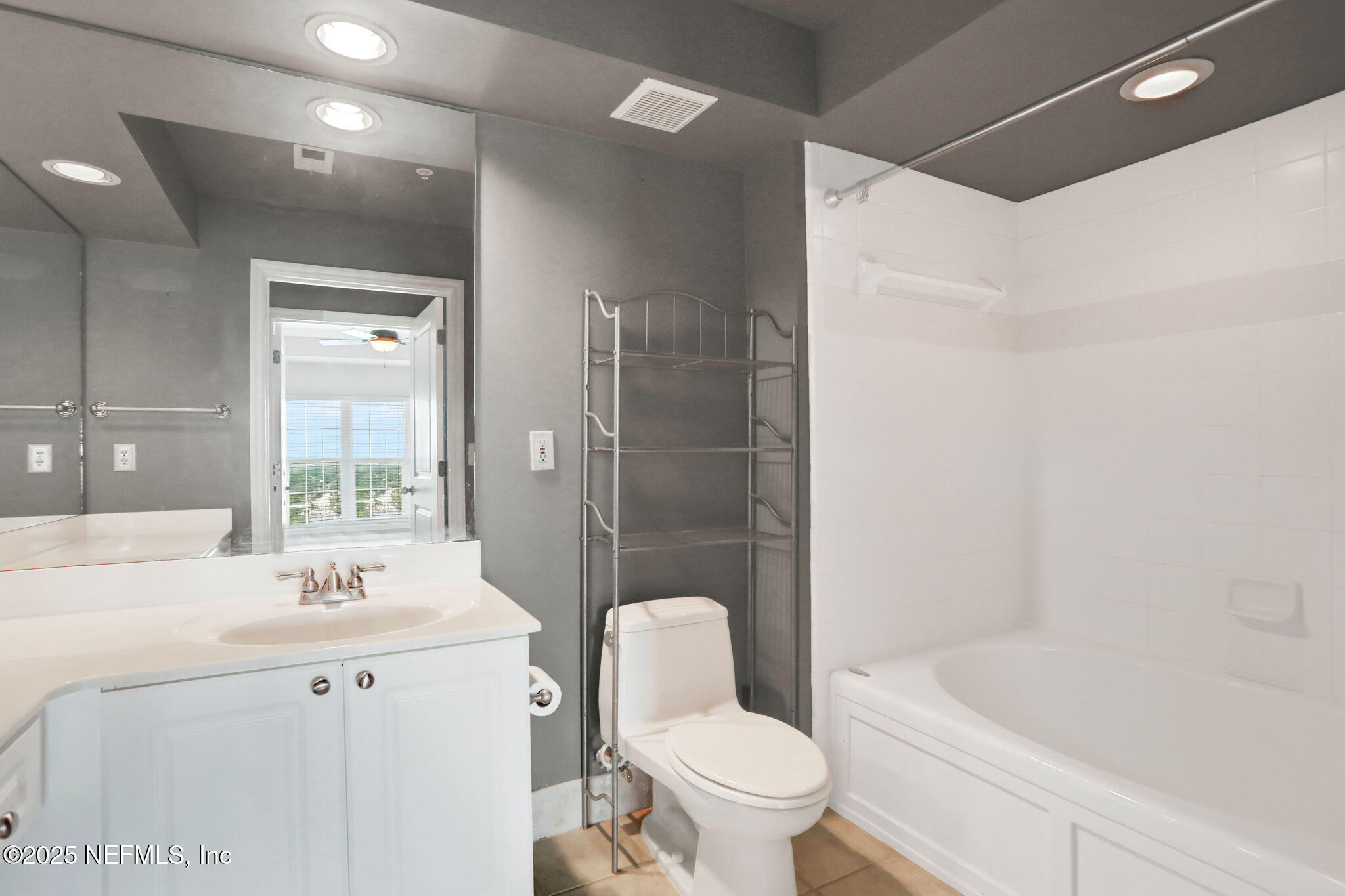 400 East Bay Street, Unit 1705 Jacksonville, FL 32202 - Photo 33 of 68 a bathroom with a bathtub shower sink vanity mirror and toilet