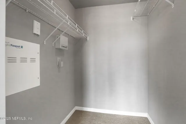 a living room with furniture a clock and a large window