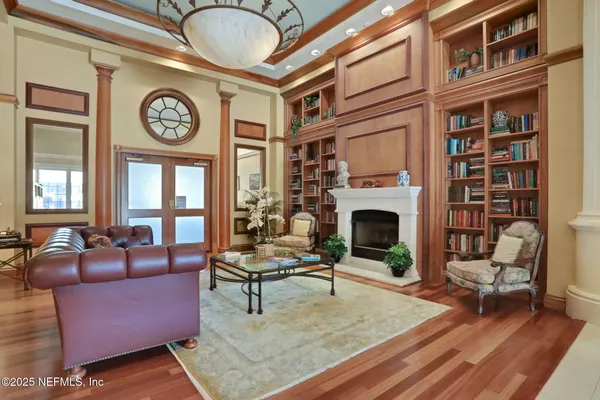 a living room with furniture and large windows
