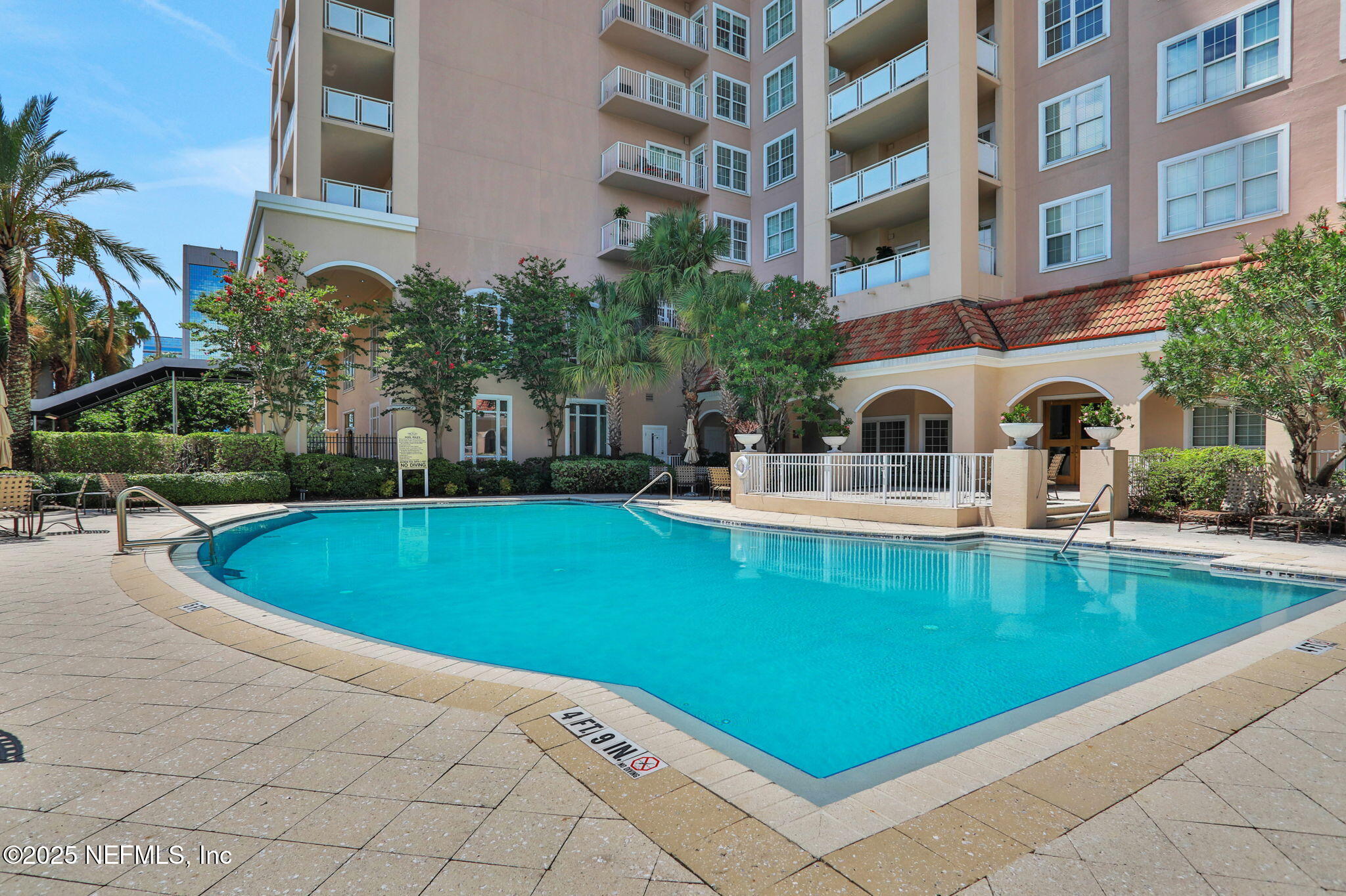 400 East Bay Street, Unit 1705 Jacksonville, FL 32202 - Photo 47 of 68 a view of a swimming pool with a bench and trees in the background