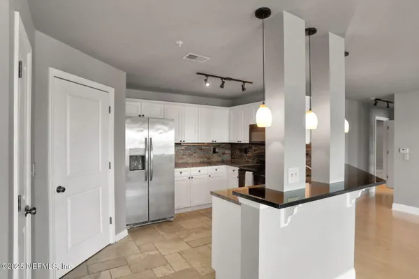 a living room with fireplace furniture and a large window