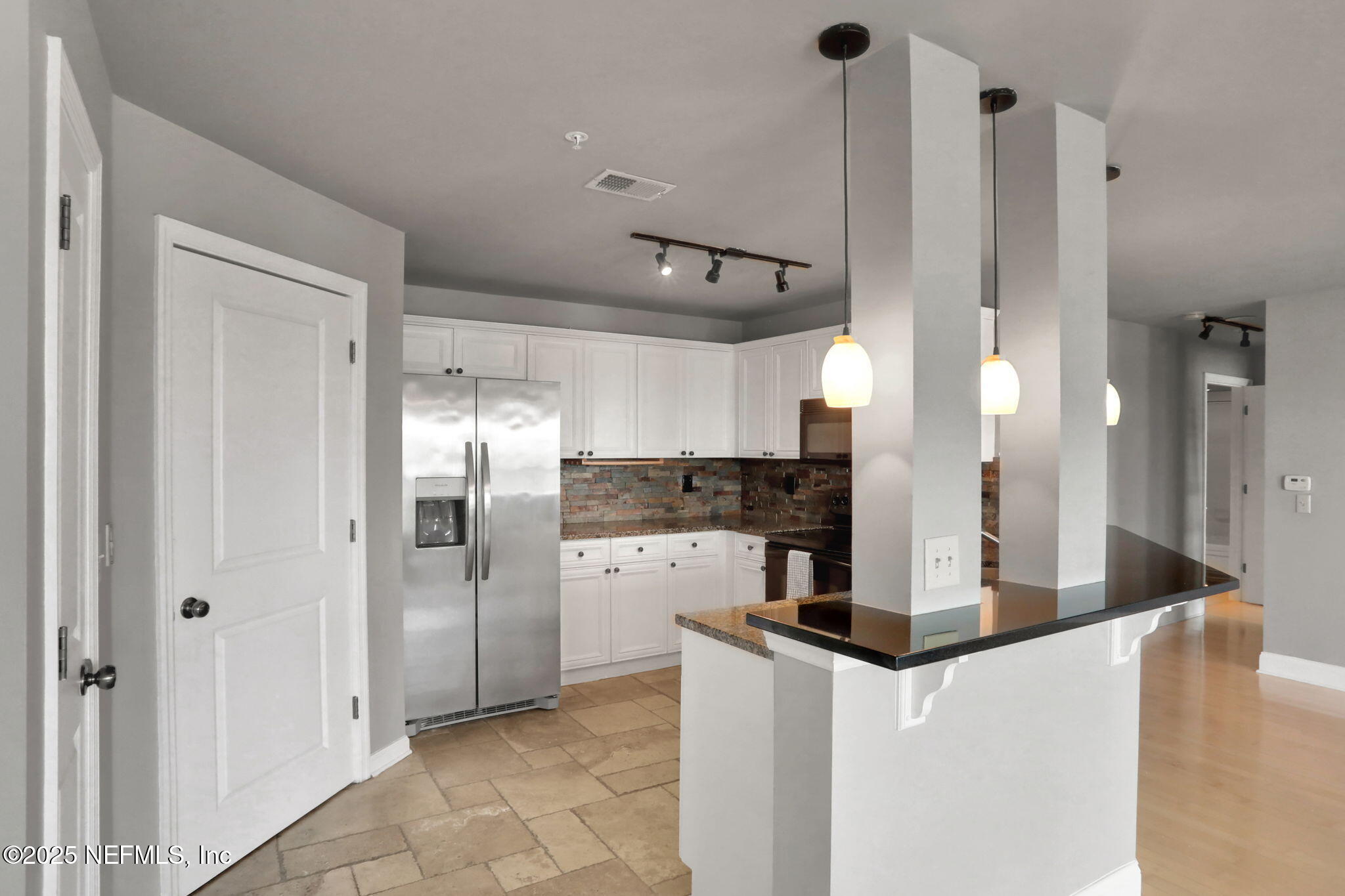 400 East Bay Street, Unit 1705 Jacksonville, FL 32202 - Photo 6 of 68 a kitchen with stainless steel appliances kitchen island a refrigerator a sink and a counter top space