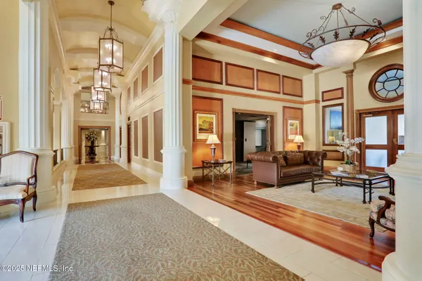 a view of a swimming pool with a lounge chair and palm trees
