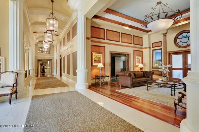 a view of a swimming pool with a lounge chair and palm trees