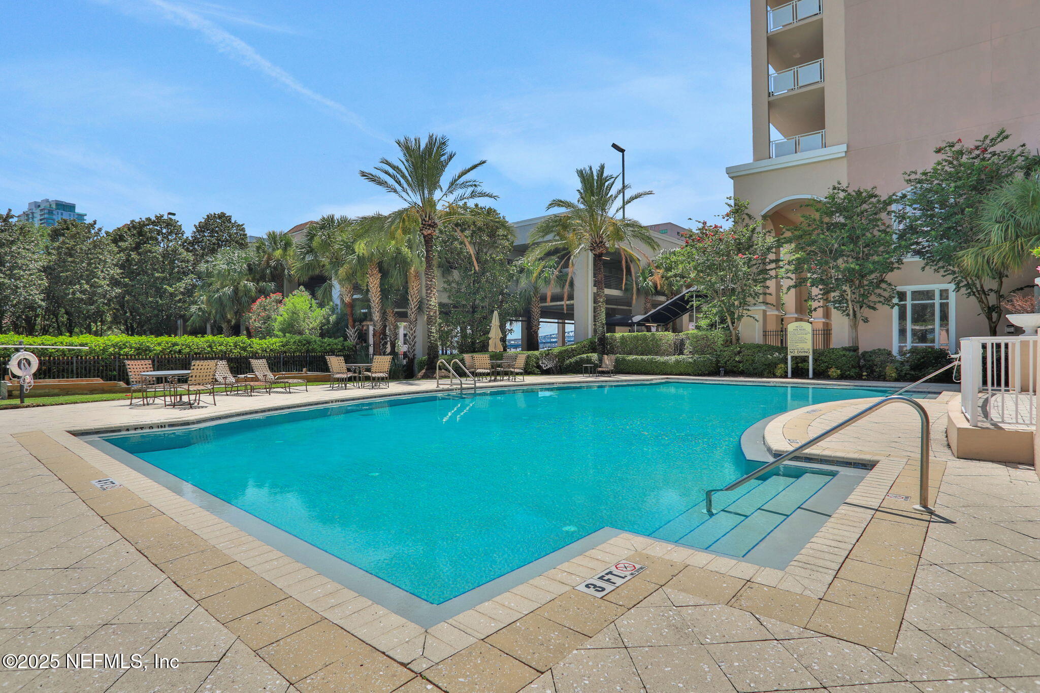 400 East Bay Street, Unit 1705 Jacksonville, FL 32202 - Photo 8 of 68 a view of a swimming pool with a lounge chair and palm trees