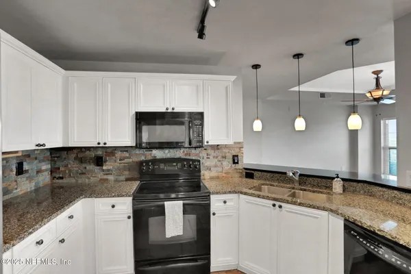 a kitchen with a sink stove and refrigerator