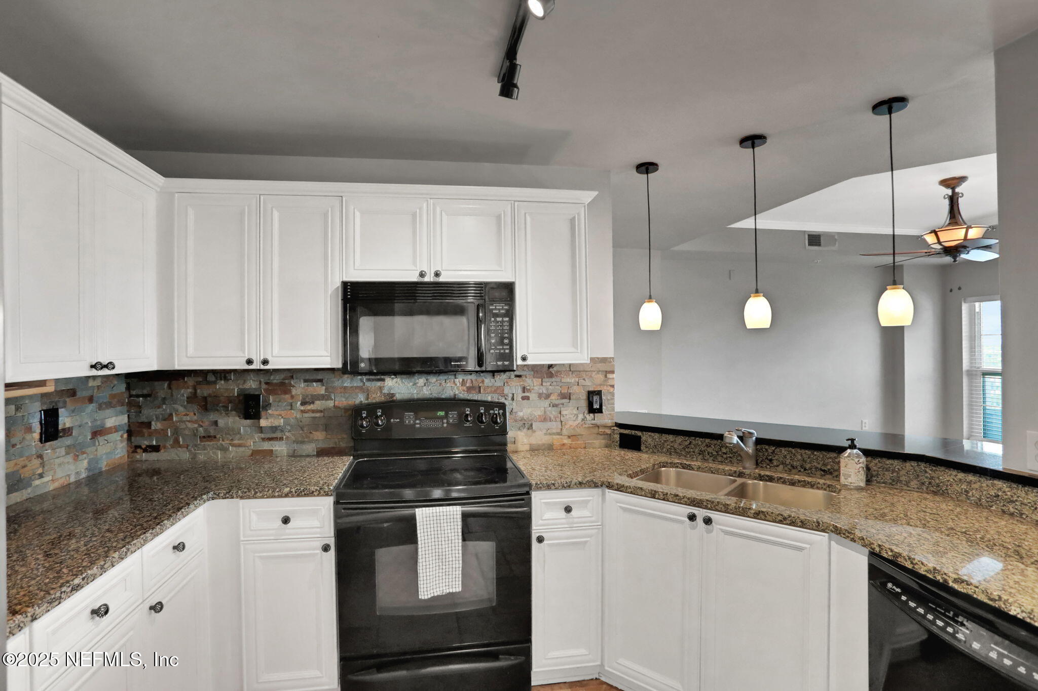 400 East Bay Street, Unit 1705 Jacksonville, FL 32202 - Photo 10 of 68 a kitchen with a sink and a stove top oven
