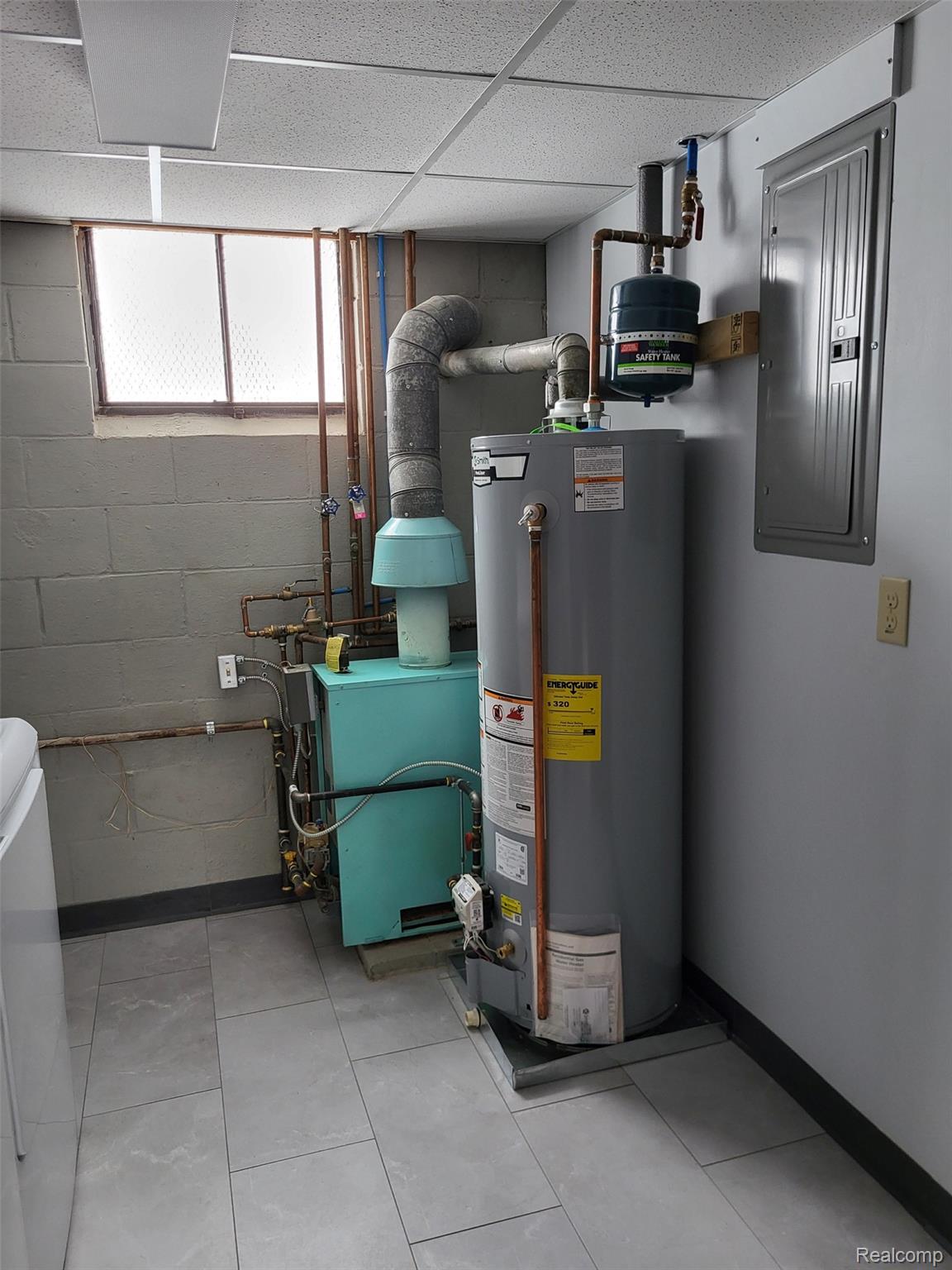 4662 North Lapeer Road Columbiaville, MI 48421 - Photo 13 of 19 Utility room with water heater, electric panel, and a heating unit