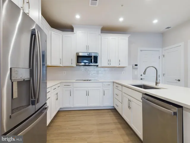 a kitchen with white cabinets and a sink