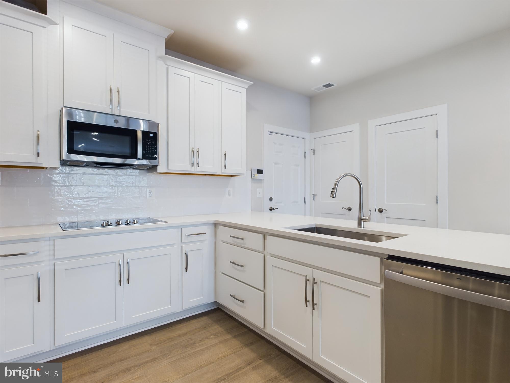 43801 Middleway Terrace Ashburn, VA 20147 - Photo 13 of 54 a kitchen with white cabinets a sink and dishwasher