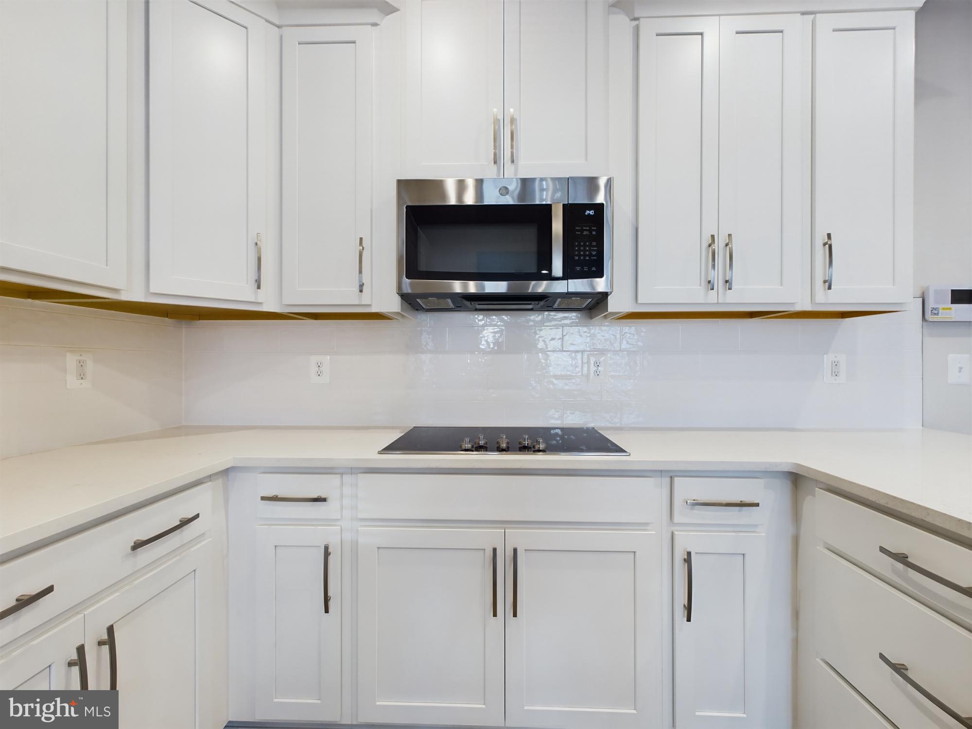43801 Middleway Terrace Ashburn, VA 20147 - Photo 14 of 54 a kitchen with white cabinets and a sink