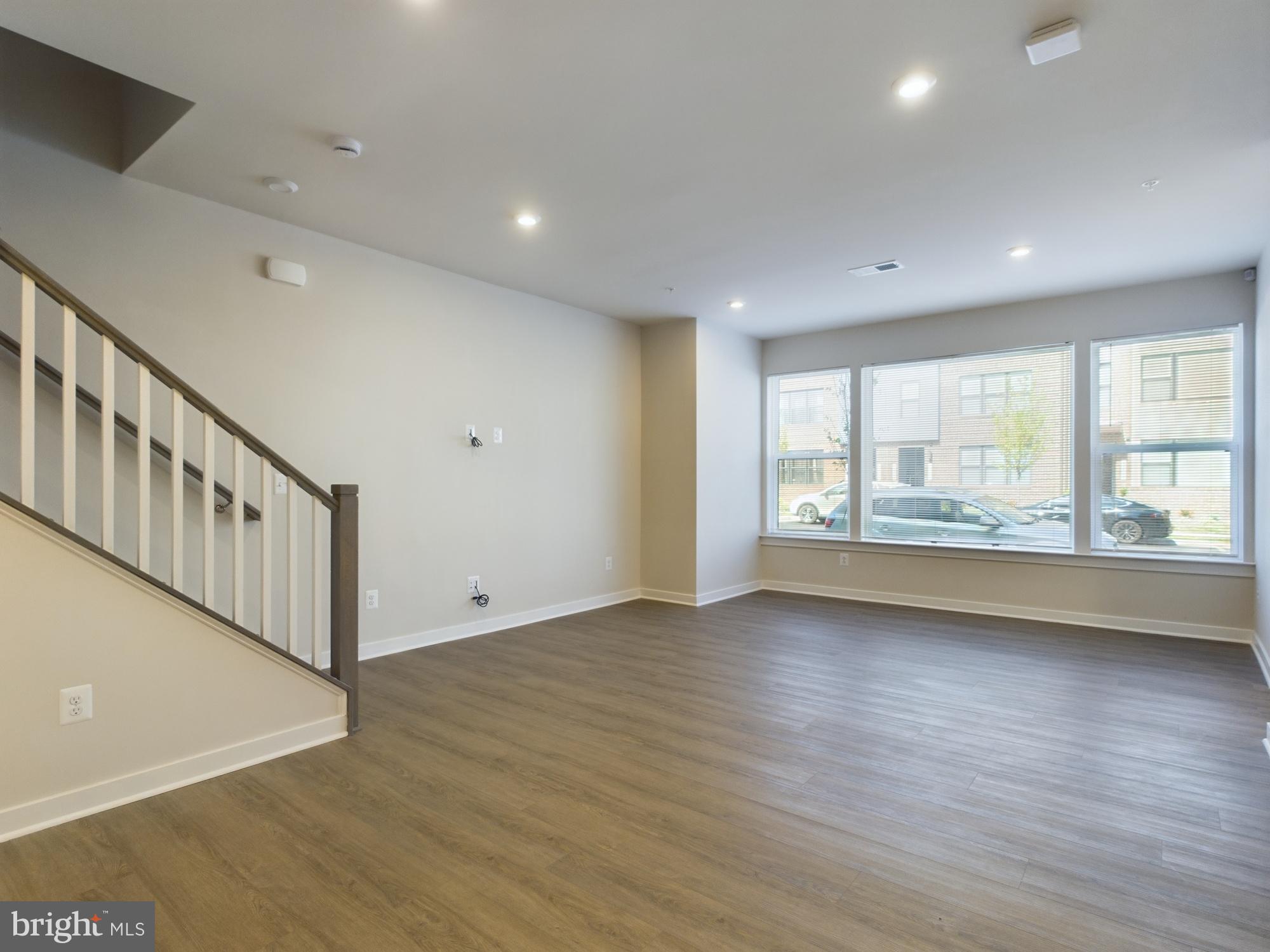 43801 Middleway Terrace Ashburn, VA 20147 - Photo 17 of 54 an empty room with wooden floor and windows