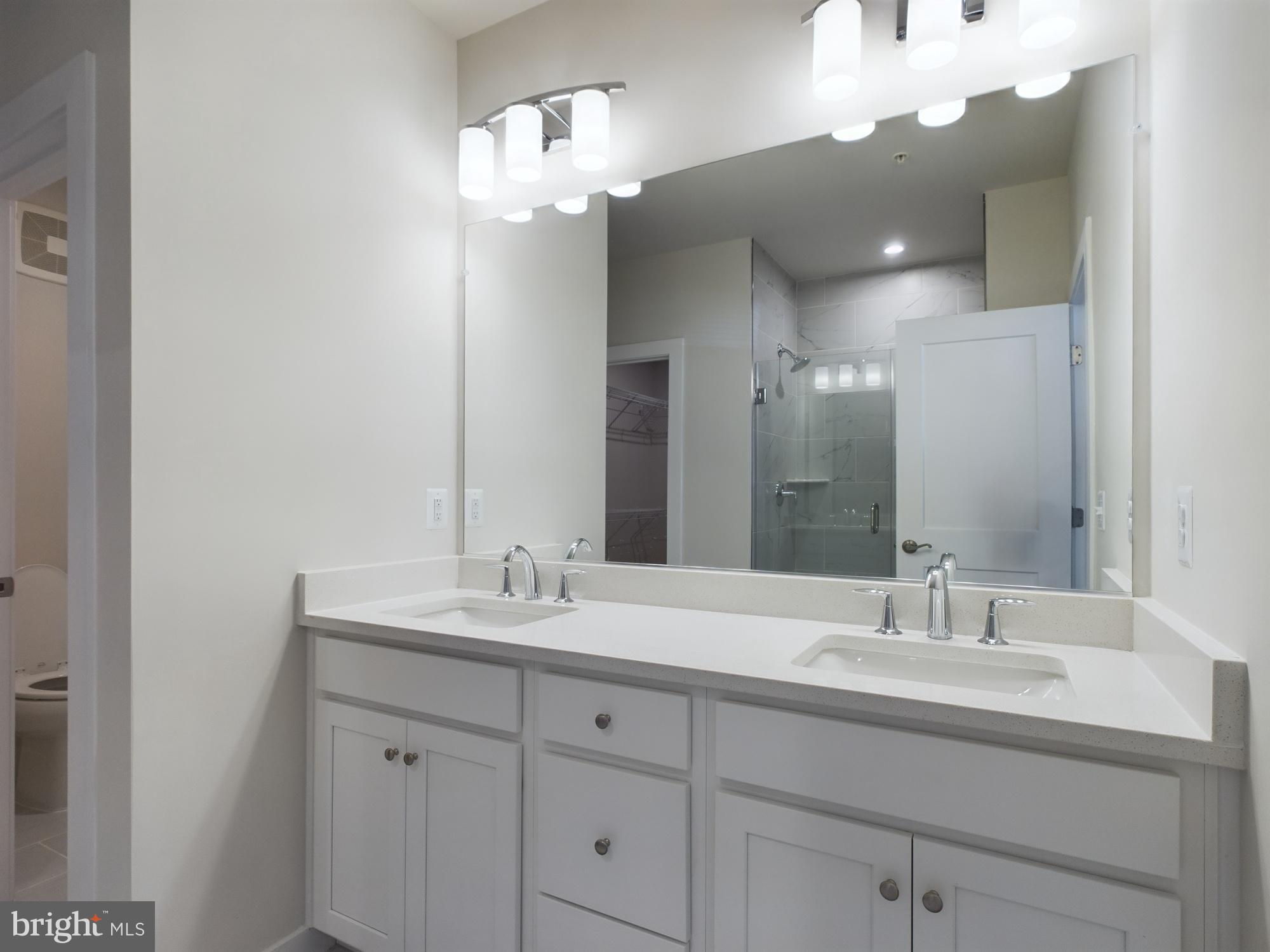 43801 Middleway Terrace Ashburn, VA 20147 - Photo 32 of 54 a bathroom with a sink double vanity and a mirror