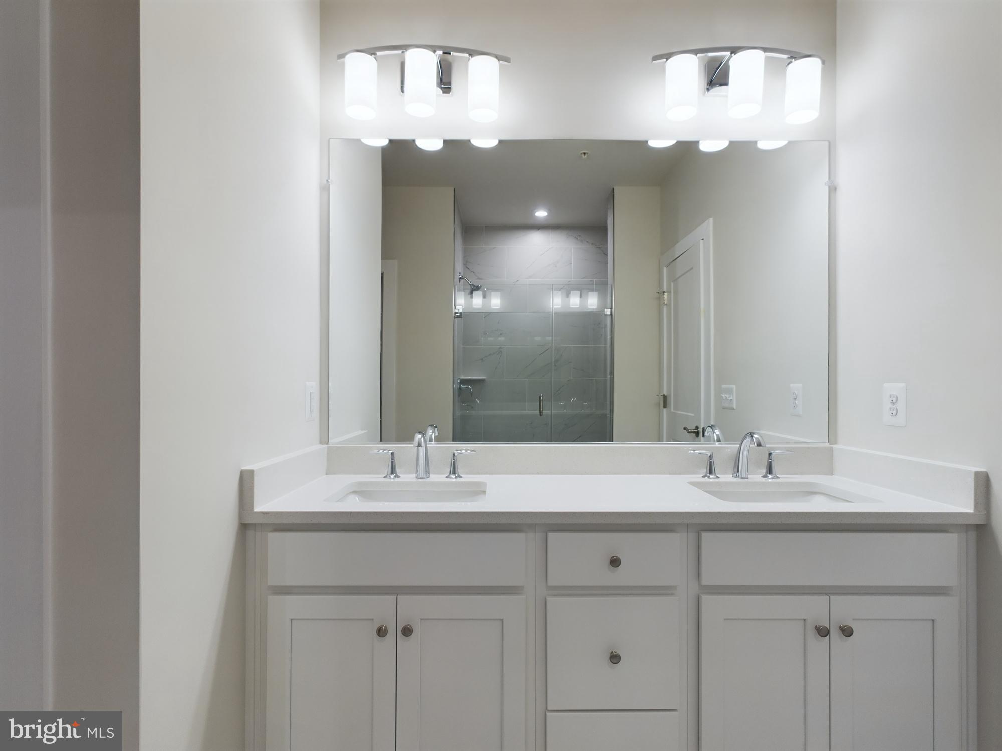 43801 Middleway Terrace Ashburn, VA 20147 - Photo 33 of 54 a bathroom with a sink vanity and a mirror