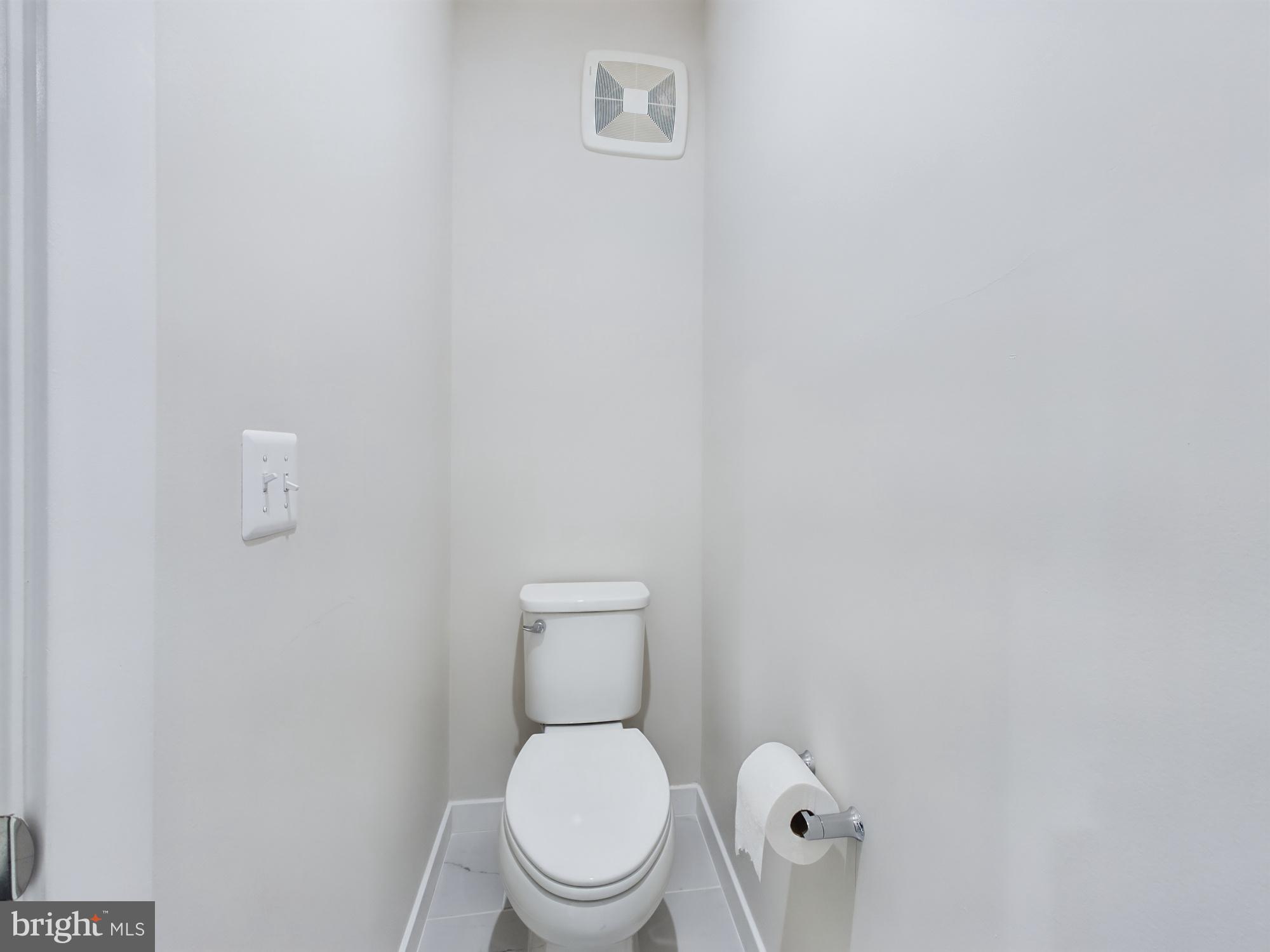 43801 Middleway Terrace Ashburn, VA 20147 - Photo 35 of 54 a white toilet sitting next to a white wall
