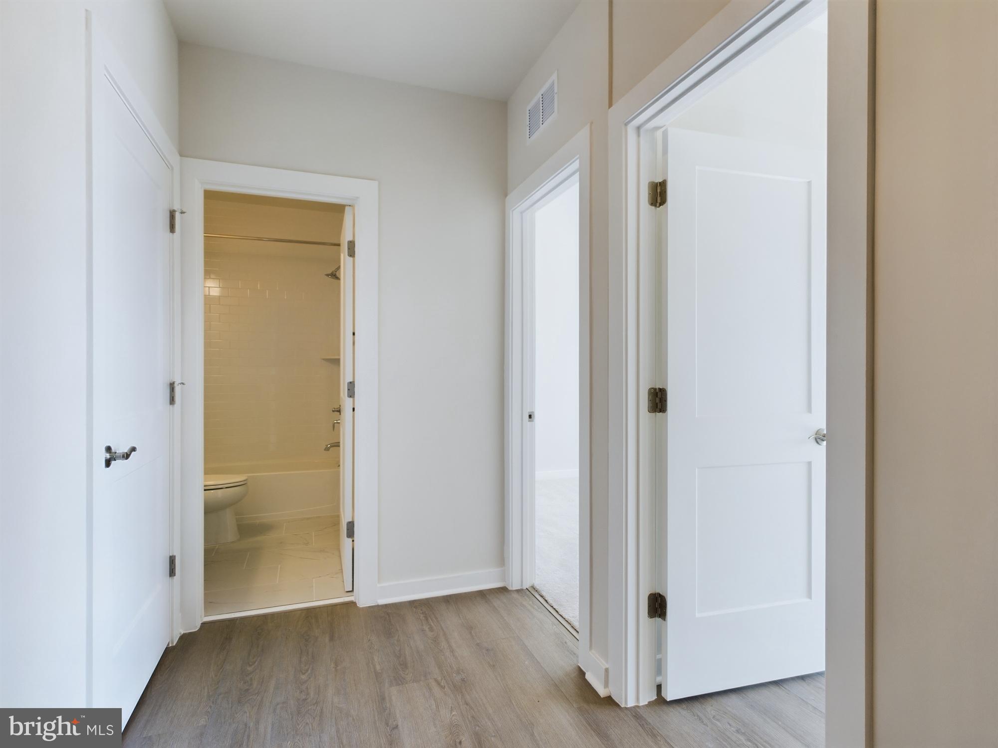 43801 Middleway Terrace Ashburn, VA 20147 - Photo 39 of 54 a view of an empty room with wooden floor and door