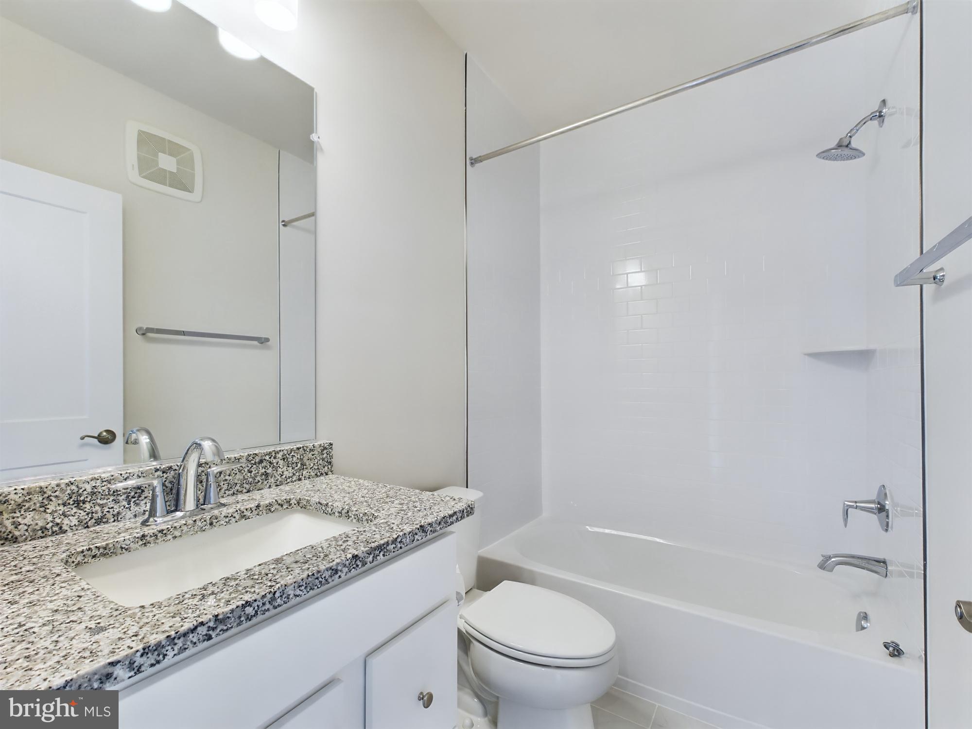 43801 Middleway Terrace Ashburn, VA 20147 - Photo 44 of 54 a bathroom with a granite countertop sink a toilet and shower