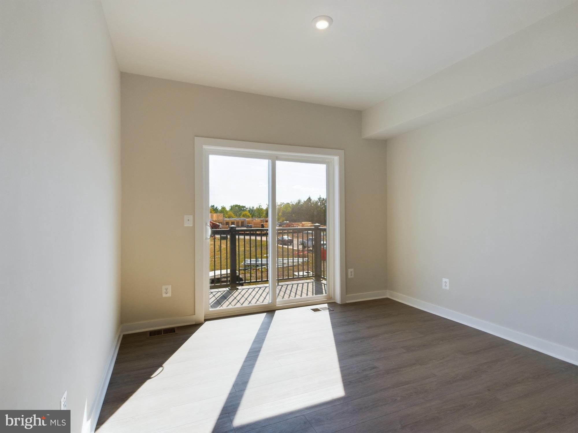 43801 Middleway Terrace Ashburn, VA 20147 - Photo 45 of 54 an empty room with wooden floor and windows