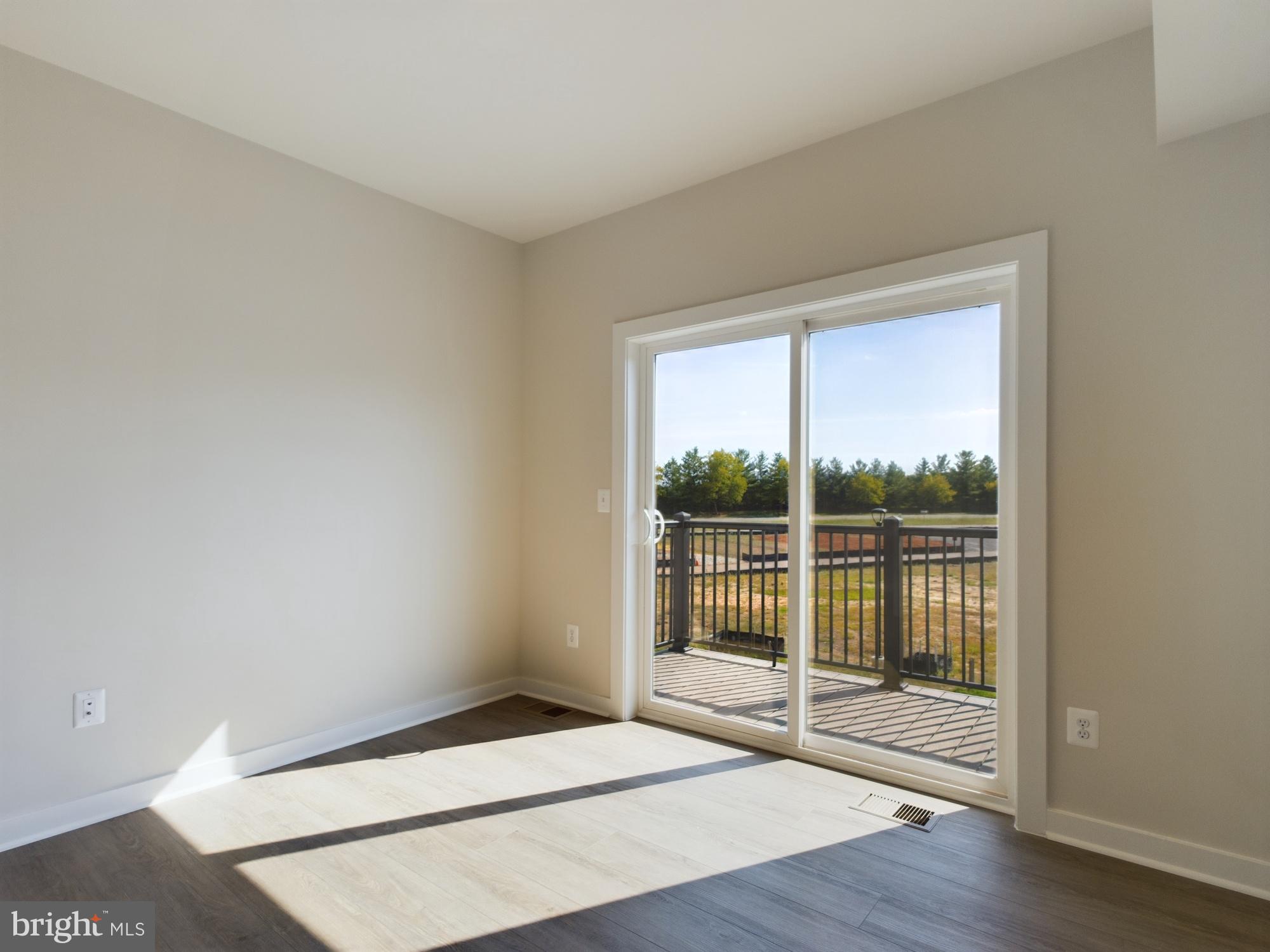 43801 Middleway Terrace Ashburn, VA 20147 - Photo 48 of 54 a view of an empty room with wooden floor and a window