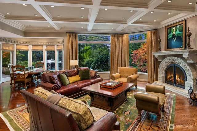 a living room with furniture a fireplace and a floor to ceiling window
