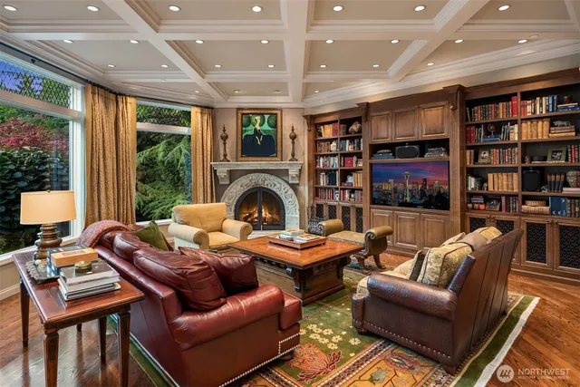 a living room with furniture a bookshelf and a large window