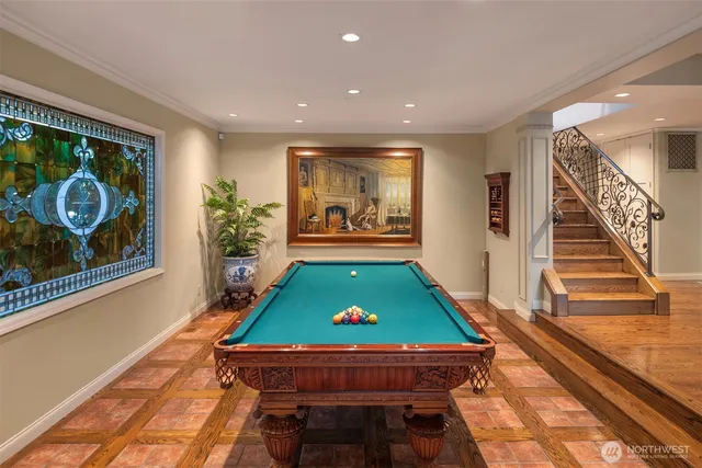 a room with pool table and wooden floor