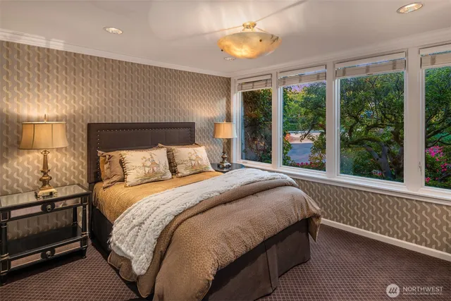 a bed sitting in a bedroom next to a window