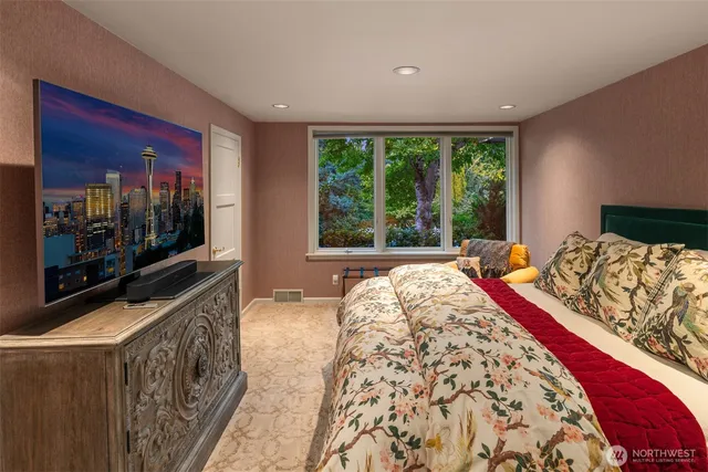 a bed sitting in a bedroom next to a window