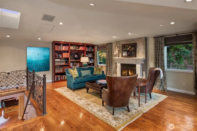 a living room with furniture a fireplace and a flat screen tv