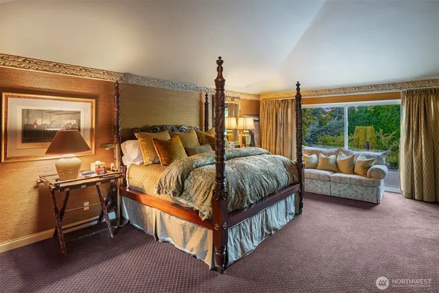 a spacious bedroom with a bed and a chandelier