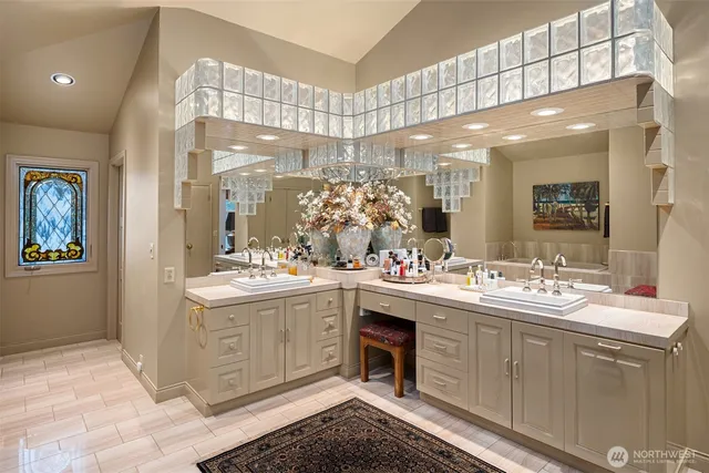a bathroom with a sink a large mirror and a shower