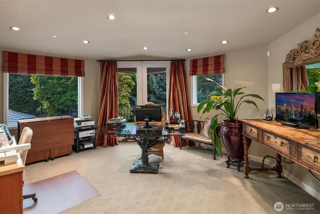 a living room with furniture a floor to ceiling window and a table