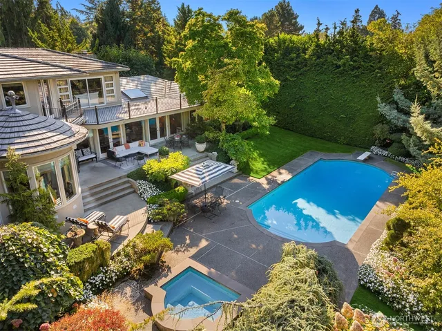 an aerial view of a house with garden space and street view