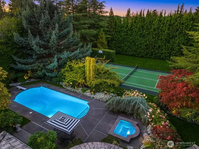 an aerial view of a tennis ground and a yard