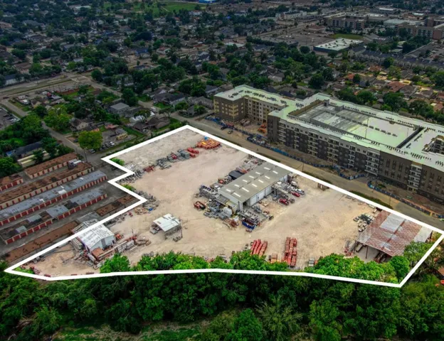 an aerial view of a residential houses with outdoor space