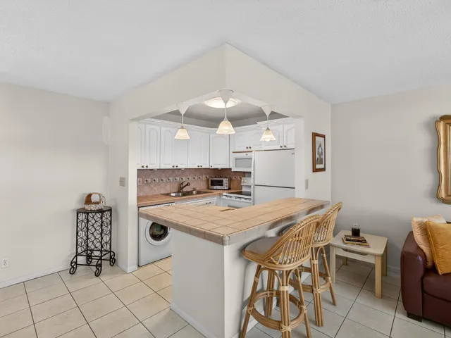 a kitchen with a table chairs and a stove