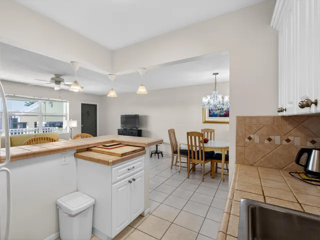 a kitchen with a sink and chairs