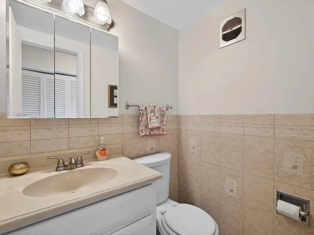 a bathroom with a sink toilet and mirror