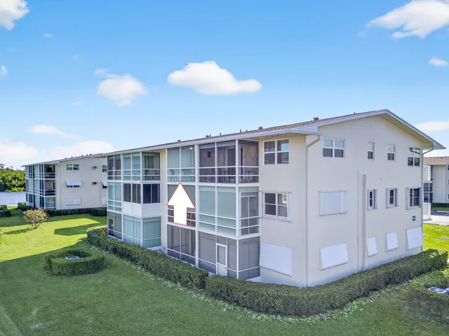 a view of a house with backyard sitting area and garden