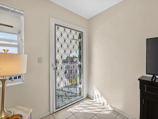 a view of a livingroom with wooden floor and a flat screen tv
