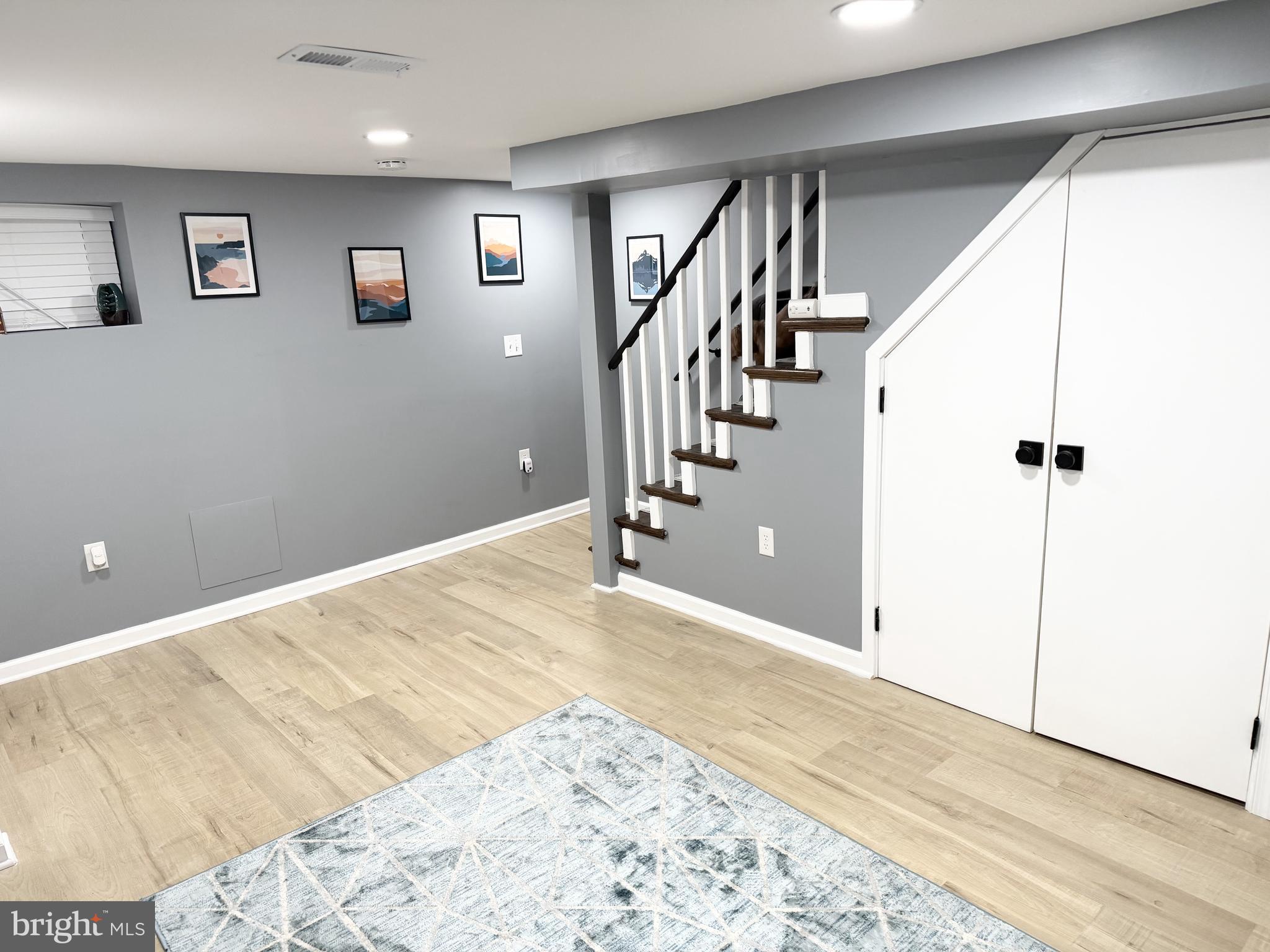 161 Elmira Street Southwest Washington, DC 20032 - Photo 14 of 23 a view of a big room with wooden floor and staircase