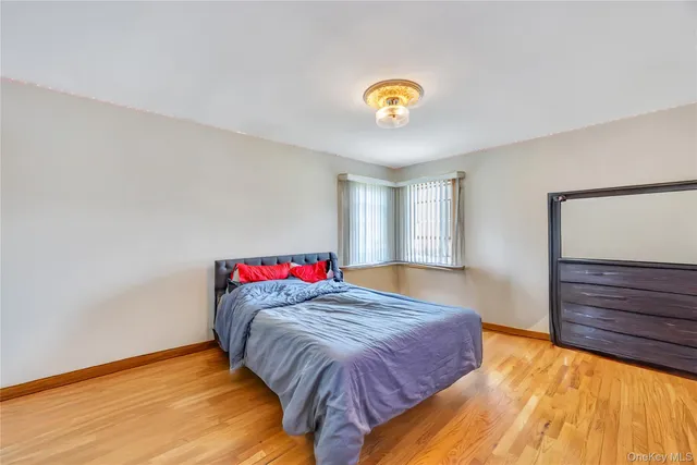 a bed sitting in a bedroom next to a cabinet