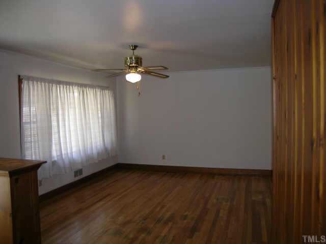 2423 Andor Place Raleigh, NC 27604 - Photo 3 of 6 an empty room with wooden floor and windows