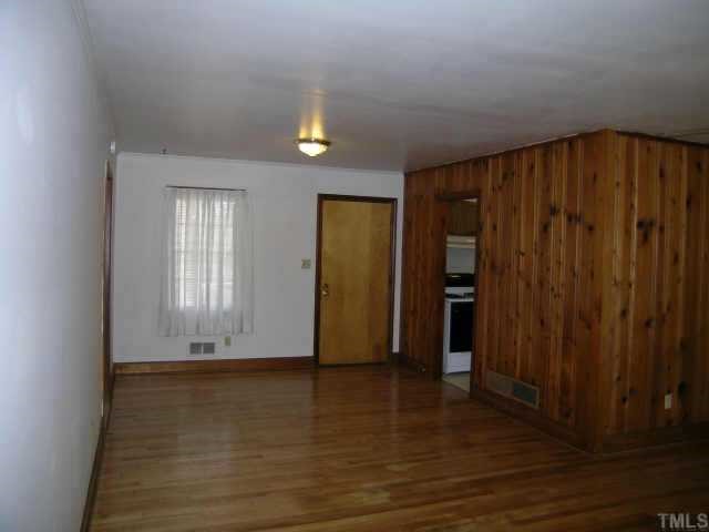 2423 Andor Place Raleigh, NC 27604 - Photo 4 of 6 a view of an empty room with wooden floor and closet area
