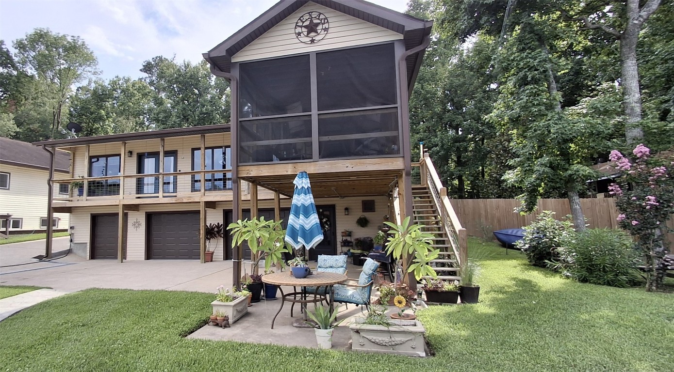 View of back of house from lake. Screened in porch upstairs and covered downstairs for lovely views of the lake!