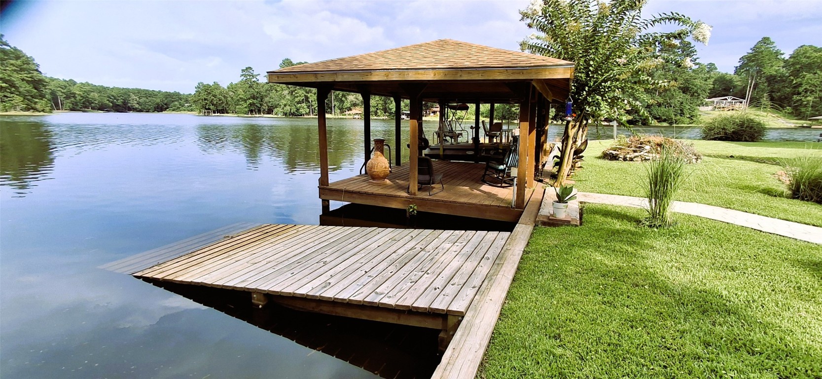 318 Ridgewood Road Goodrich, TX 77335 - Photo 37 of 49 a view of a backyard with sitting area and lake view