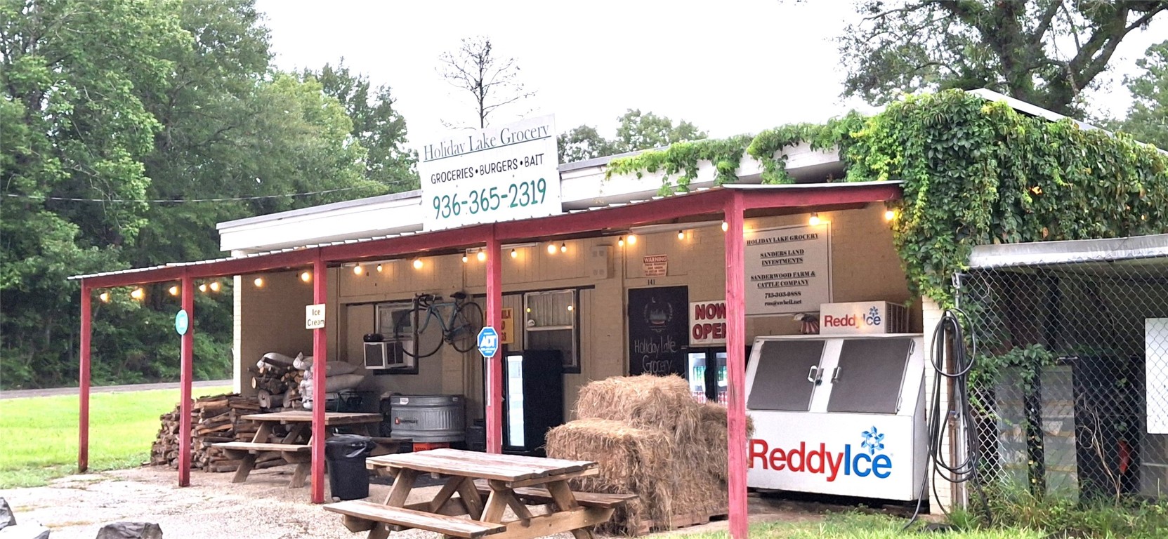 318 Ridgewood Road Goodrich, TX 77335 - Photo 47 of 49 a view of a patio with table and chairs potted plants and floor to ceiling window