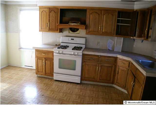 1 Fulton Street Keyport, NJ 07735 - Photo 2 of 3 a kitchen with a stove a microwave and a sink