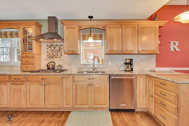a kitchen with stainless steel appliances granite countertop a sink and cabinets